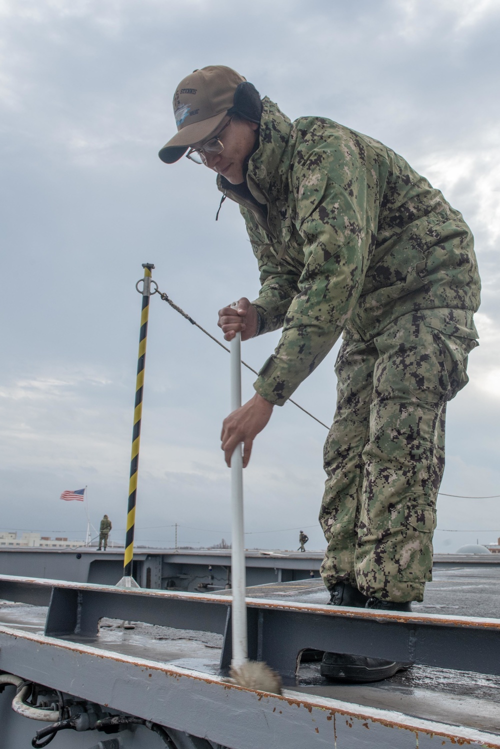 Sailor cleans flight deck