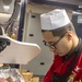 Sailors and Marines cook in the New York's galley