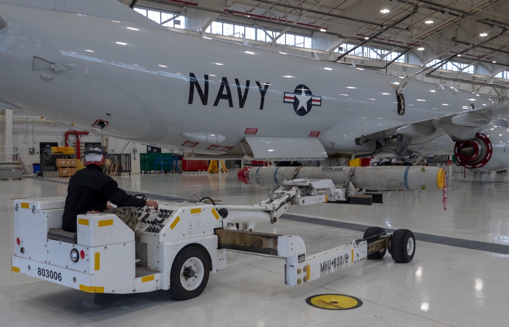 Sailors assigned to Patrol Squadron 46 Load ordnance