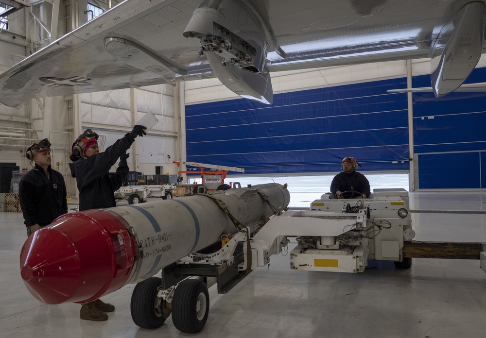 Sailors assigned to Patrol Squadron 46 Load ordnance