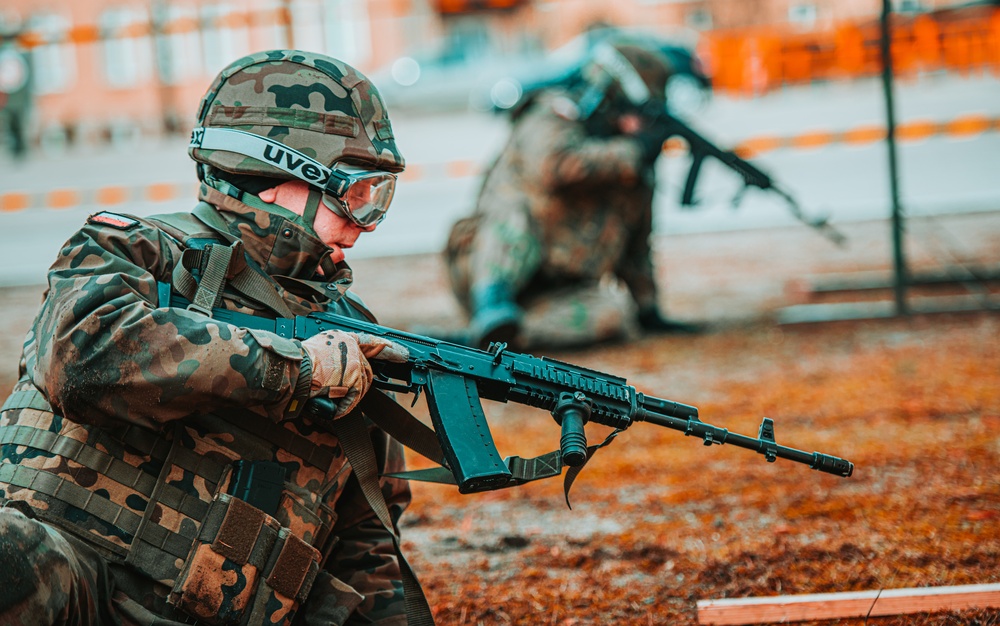 NATO Battle Group Poland Soldiers collaborate to put on a static display for local school children