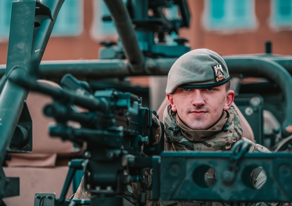 NATO Battle Group Poland Soldiers collaborate to put on a static display for local school children