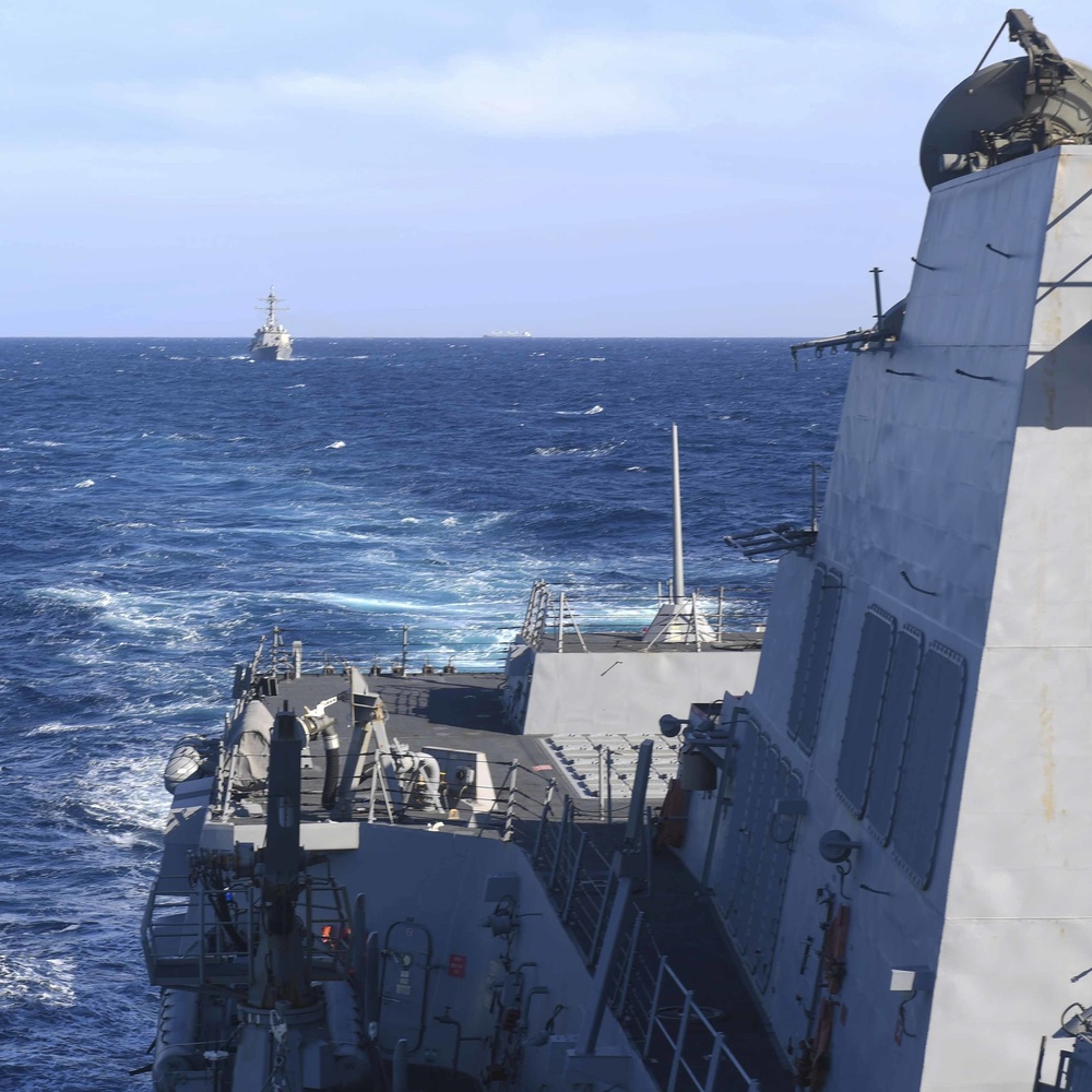 USS Ralph Jonson steams ahead of USS Halsey