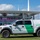 CBP Support to Super Bowl LIV A U.S. Customs and Border Protection Mobile Command vehicle is parked on grass outside Hard Rock Stadium, which is displaying 'Super Bowl LIV' signage. The white and green Ford F-150 Raptor truck bears official CBP markings and is part of security operations for the event. The image was taken during Super Bowl LIV, held in Miami, Florida in February 2020.