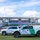 CBP Support to Super Bowl LIV Two U.S. Customs and Border Protection vehicles, including a Mobile Command unit, are parked on a grass field in front of Hard Rock Stadium displaying 'Super Bowl LIV' signage. The vehicles are marked with the distinctive green and white Border Patrol livery and DHS insignia. This appears to be a security deployment for the Super Bowl LIV event held in Miami, Florida.