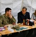 Thune and wife eat with a Soldier