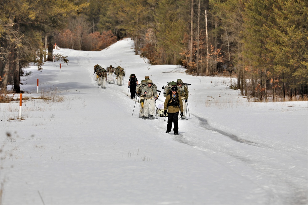 Fort McCoy Cold-Weather Operations Course Class 20-03 students practice snowshoeing, ahkio sled use