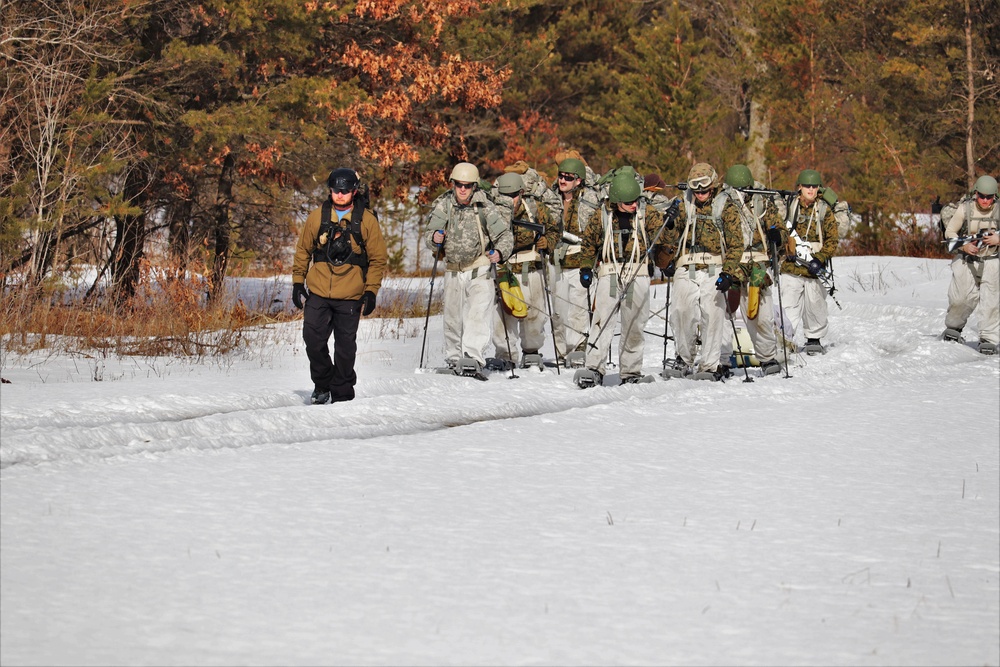 Fort McCoy Cold-Weather Operations Course Class 20-03 students practice snowshoeing, ahkio sled use