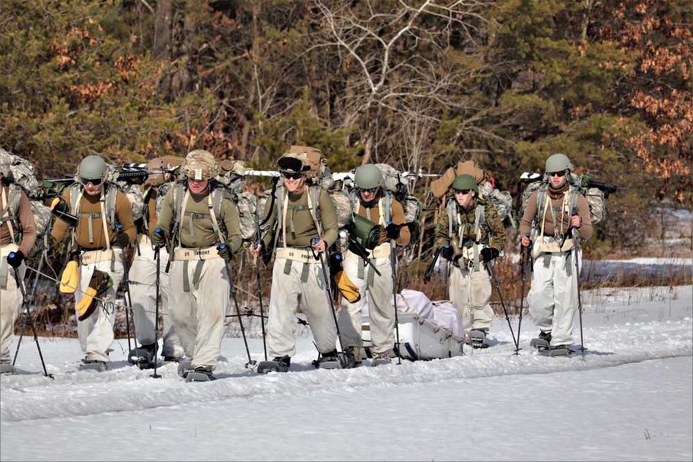 Fort McCoy Cold-Weather Operations Course Class 20-03 students practice snowshoeing, ahkio sled use
