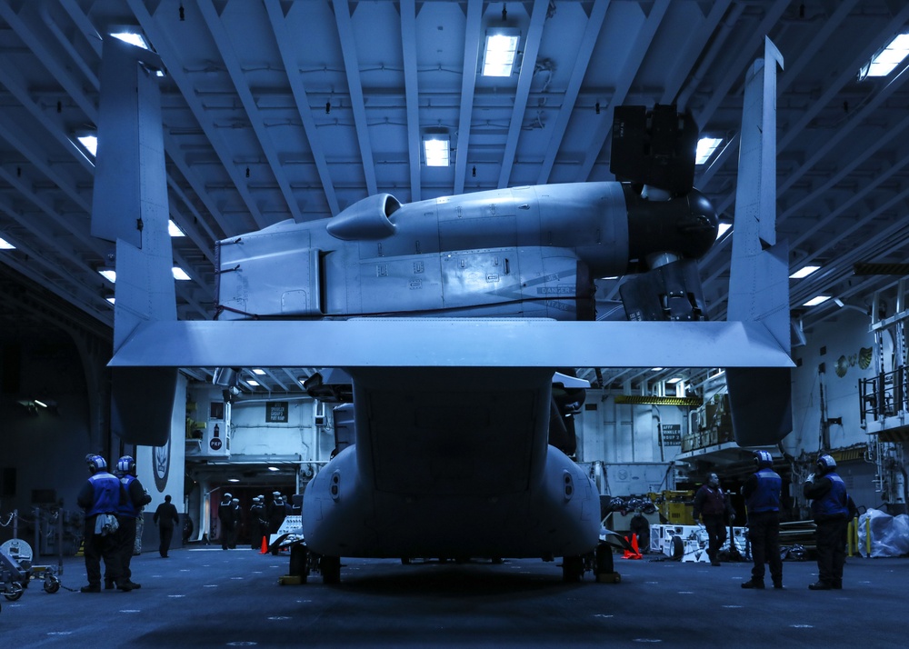 USS Makin Island has a MV-22B Osprey resting in the hangar bay.
