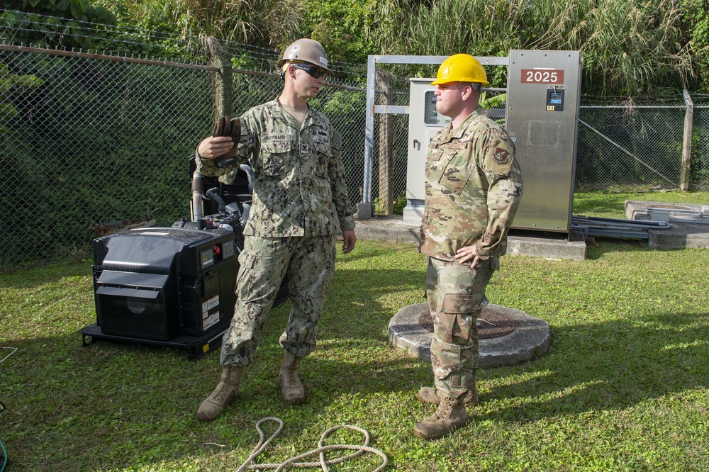 U.S. Navy Seabees with NMCB-5 replace a generator with 18th Civil Engineer Squadron