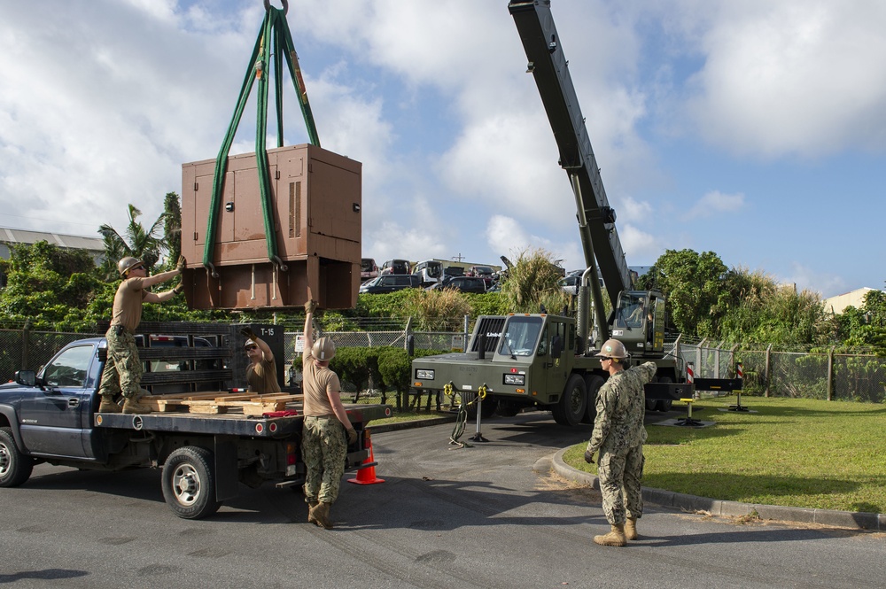 U.S. Navy Seabees with NMCB-5 replace a generator with 18th Civil Engineer Squadron