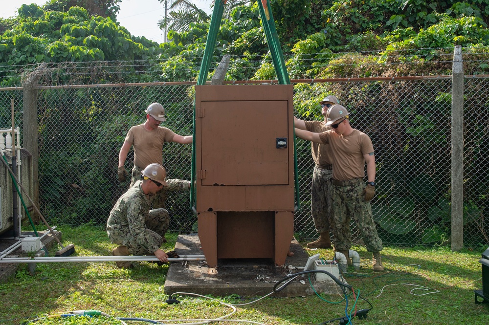 U.S. Navy Seabees with NMCB-5 replace a generator with 18th Civil Engineer Squadron