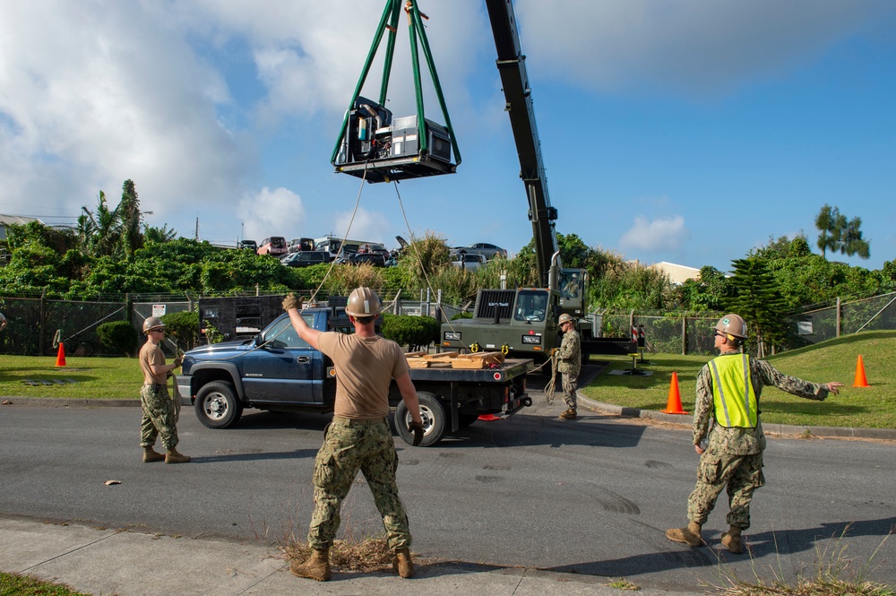 U.S. Navy Seabees with NMCB-5 replace a generator with 18th Civil Engineer Squadron