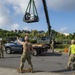 U.S. Navy Seabees with NMCB-5 replace a generator with 18th Civil Engineer Squadron