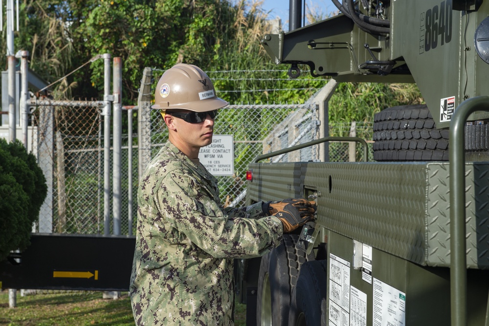 U.S. Navy Seabees with NMCB-5 replace a generator with 18th Civil Engineer Squadron