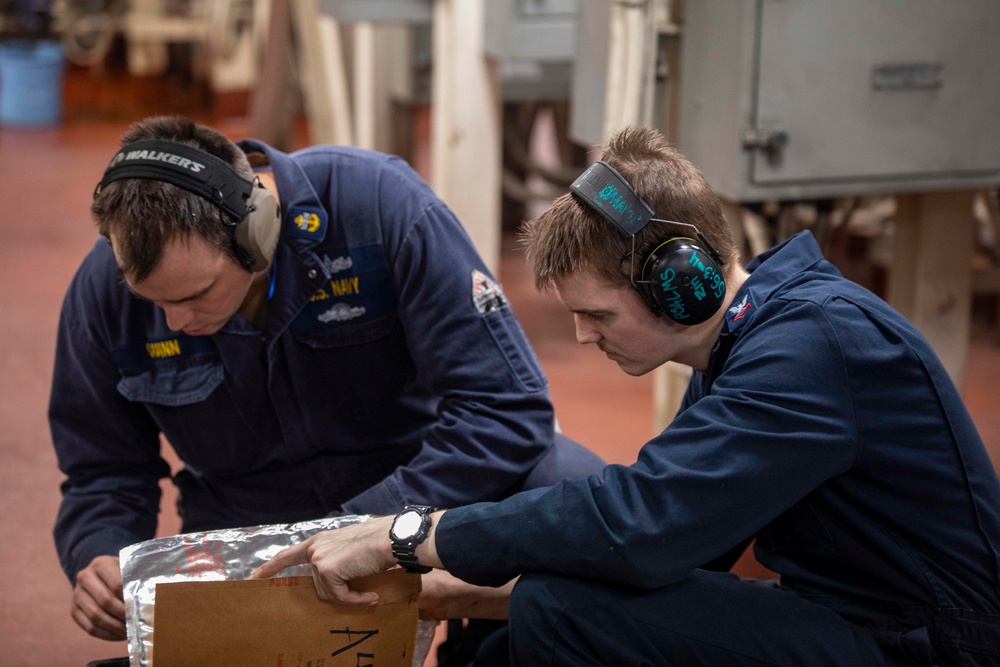 Sailors repair an RO HP pump