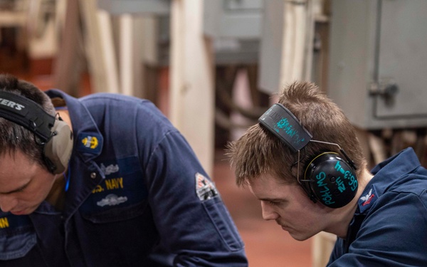 Sailors repair an RO HP pump