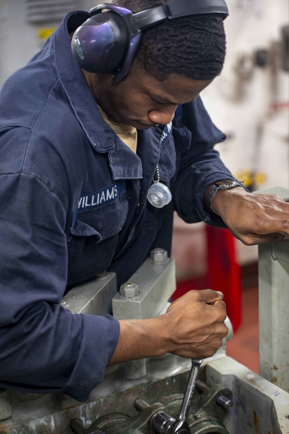 Sailors repair an RO HP pump