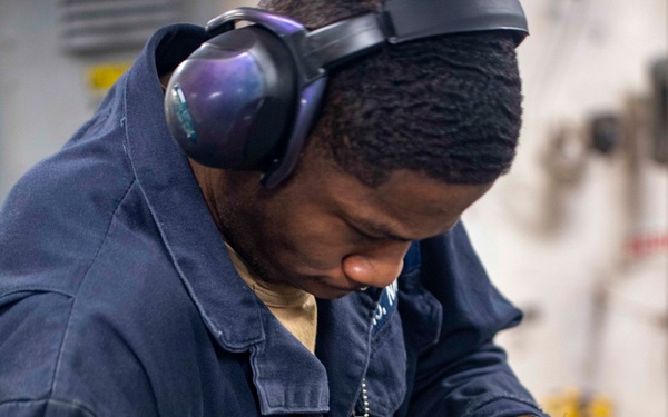Sailors repair an RO HP pump