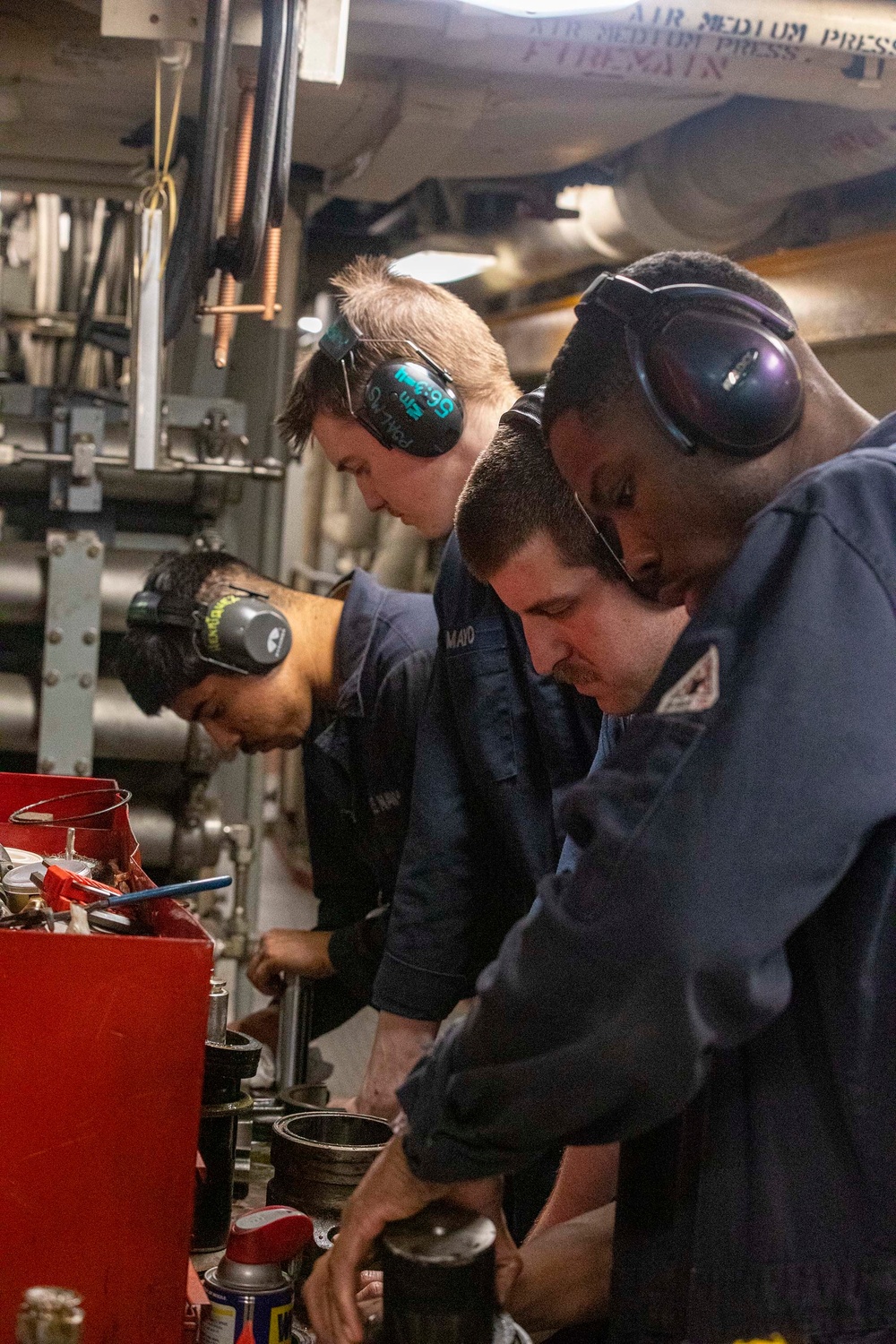 Sailors repair an RO HP pump