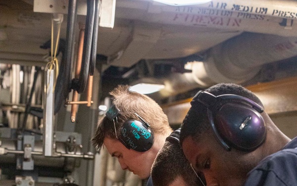 Sailors repair an RO HP pump