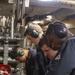 Sailors repair an RO HP pump
