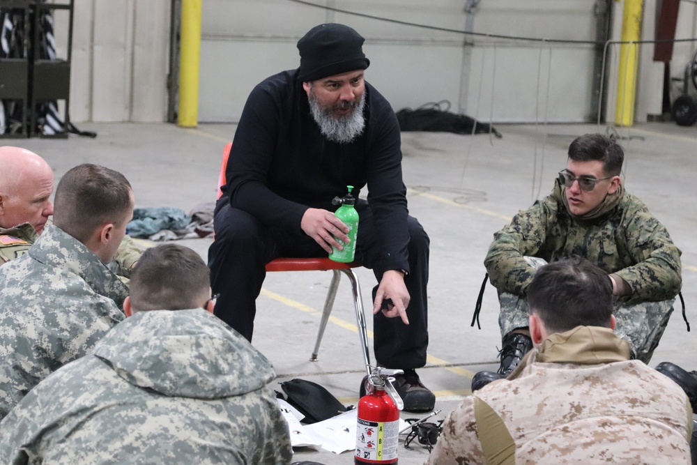 Cold-Weather Operations Course Class 20-03 students learn about equipment during training at Fort McCoy