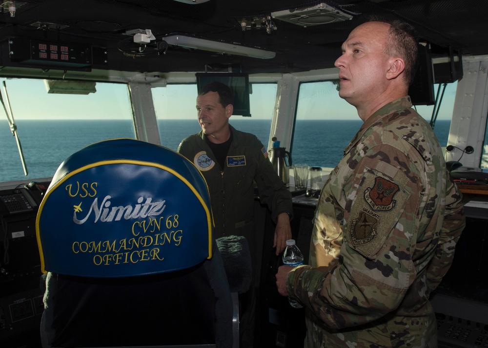 Military Personnel Observe Flight Operations