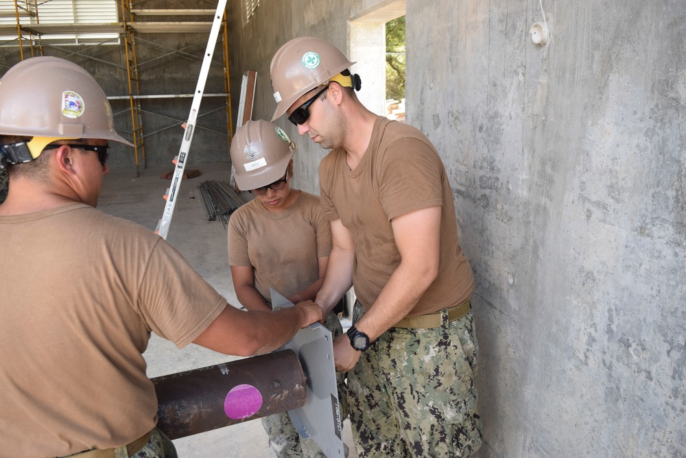 U.S. Navy Seabees with NMCB-5’s Detail Tinian continue work on Explosive Ordnance Disposal Mobile Unit 5’s Boat Storage Facility