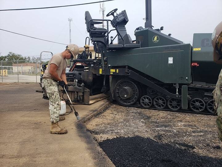 Seabees deployed with NMCB-5’s Detail Guam perform asphalt paving operations
