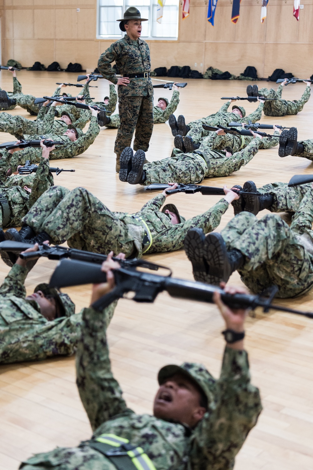 200221-N-TE695-0024 NEWPORT, R.I. (Feb. 20, 2020) -- Navy Officer Candidate School students perform remedial physical training