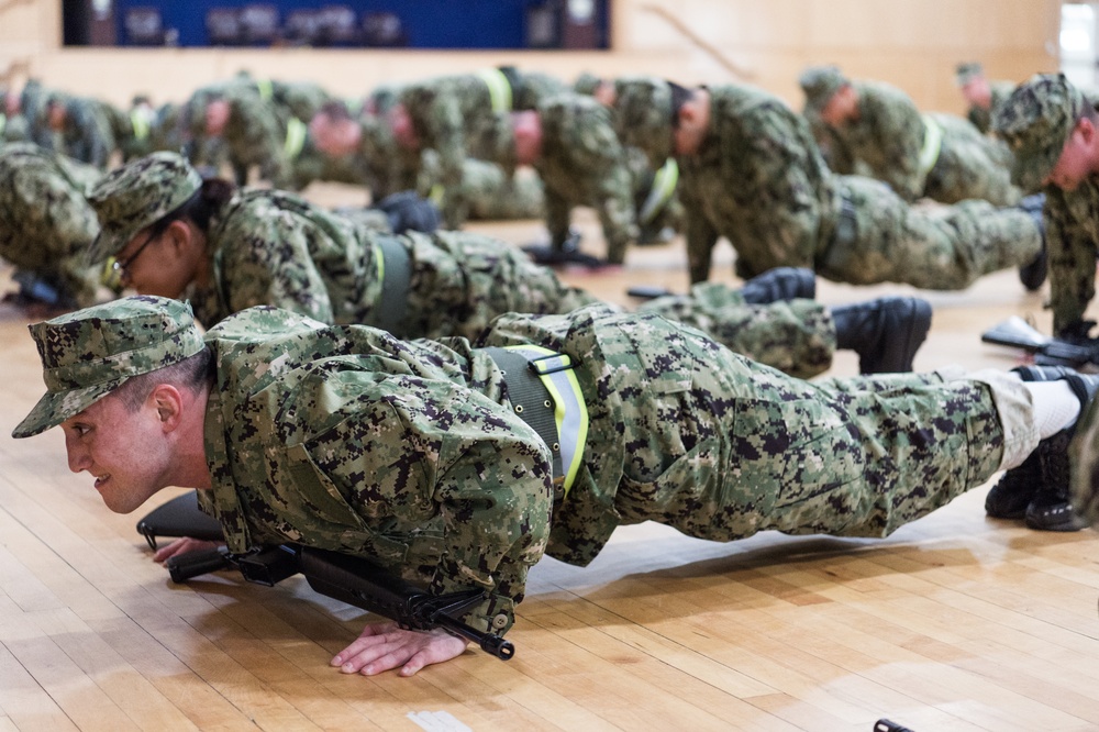 200221-N-TE695-0032 NEWPORT, R.I. (Feb. 20, 2020) -- Navy Officer Candidate School students perform remedial physical training