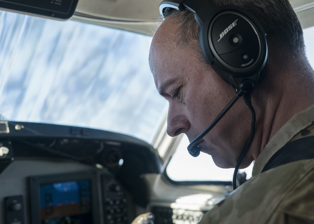 U.S. Army CWO4 Matthew Crump, pilot for Bravo Company of the 228th Aviation Regiment, reads the mid flight checklist for the C-12 Huron