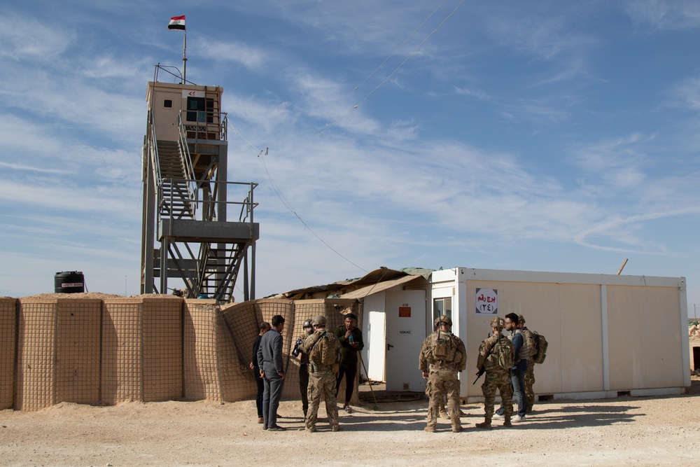 25th Infantry Division Soldiers greet Iraqi troops guarding the perimeter of Al Asad Airbase