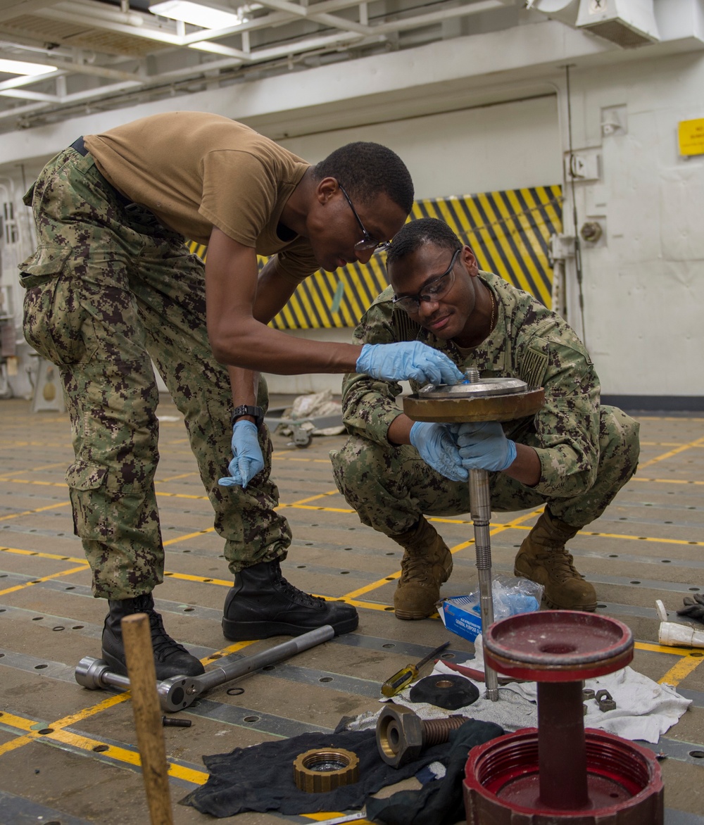 GHWB Sailors Lubricate Sprinkler System