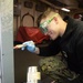 Aviation Electronics Technician 3rd Class Christopher Tennill, from Columbia, Missouri, greases door trap