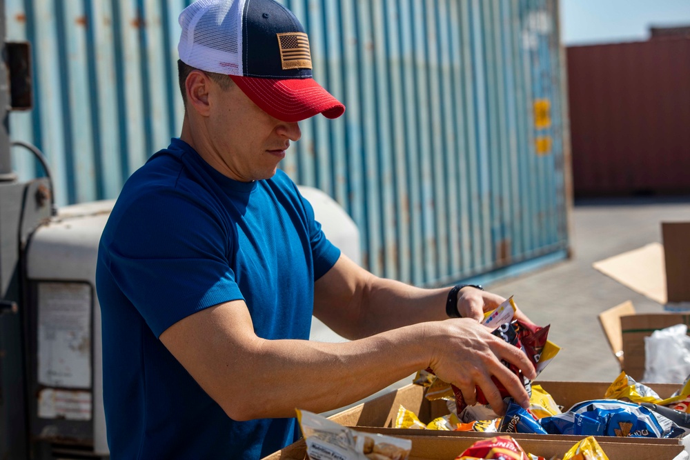 Sailors and Marines take part in a cook out on the pier