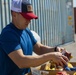 Sailors and Marines take part in a cook out on the pier