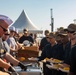 Sailors and Marines take part in a cook out on the pier