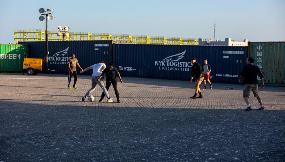 Sailors and Marines take part in a cook out on the pier