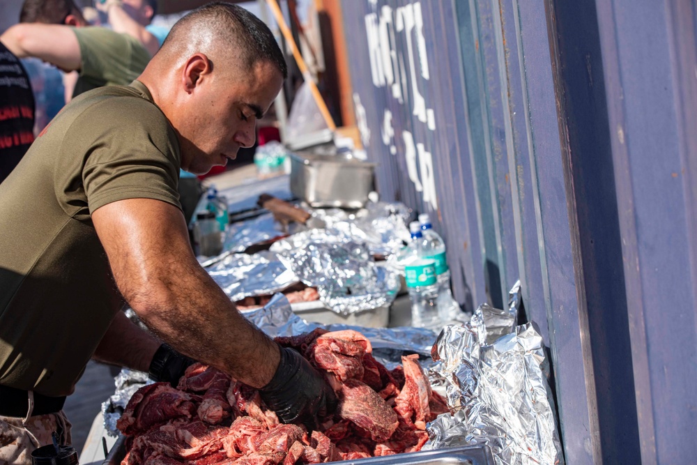 Sailors and Marines take part in a cook out on the pier