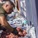 Sailors and Marines take part in a cook out on the pier