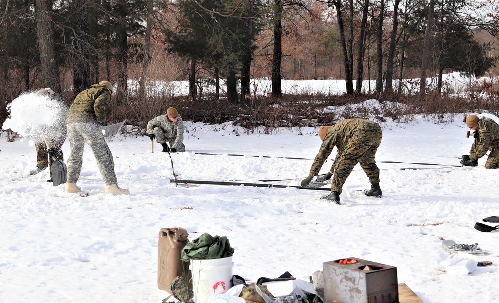 Cold-Weather Operations Course Class 20-03 students build Arctic tents during training at Fort McCoy
