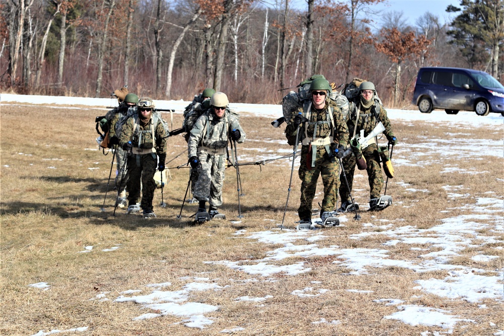 Cold-Weather Operations Course Class 20-03 students practice snowshoeing, ahkio sled use