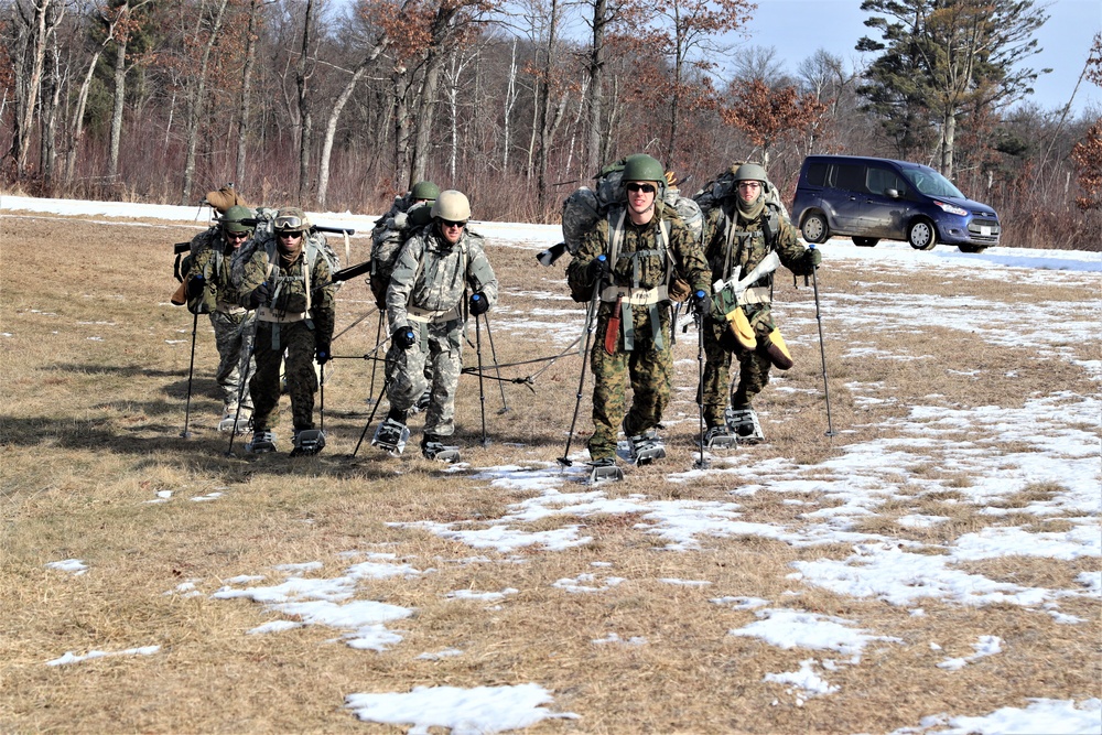 Cold-Weather Operations Course Class 20-03 students practice snowshoeing, ahkio sled use