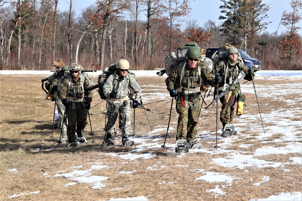 Cold-Weather Operations Course Class 20-03 students practice snowshoeing, ahkio sled use