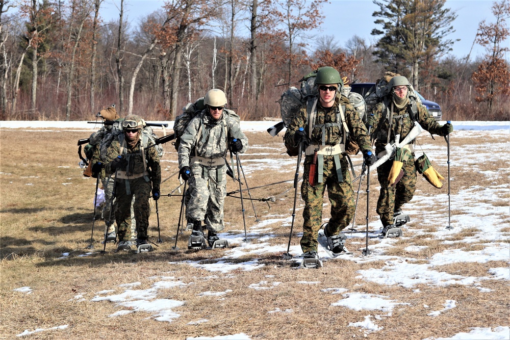 Cold-Weather Operations Course Class 20-03 students practice snowshoeing, ahkio sled use