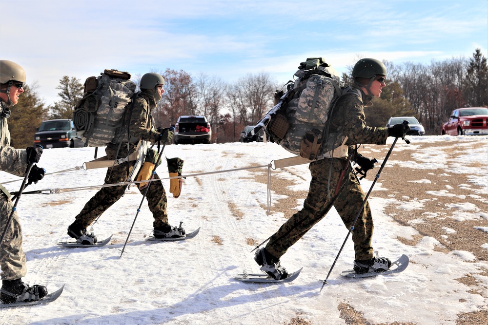 Cold-Weather Operations Course Class 20-03 students practice snowshoeing, ahkio sled use