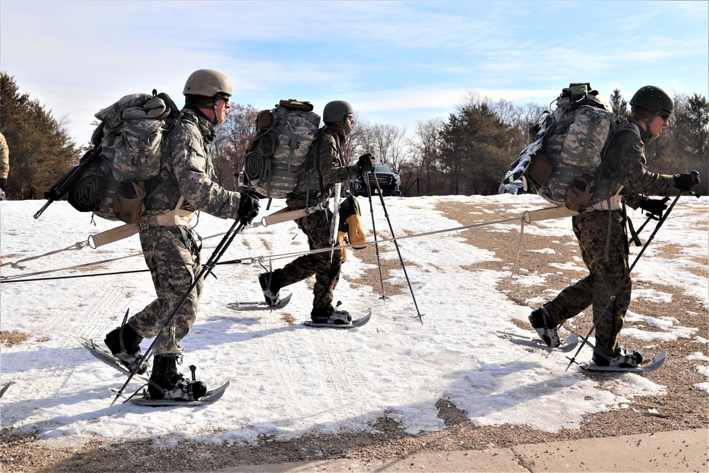 Cold-Weather Operations Course Class 20-03 students practice snowshoeing, ahkio sled use